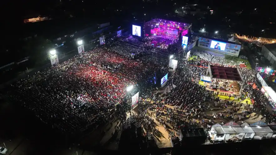 Aerial night view of a vast festival audience before the stage