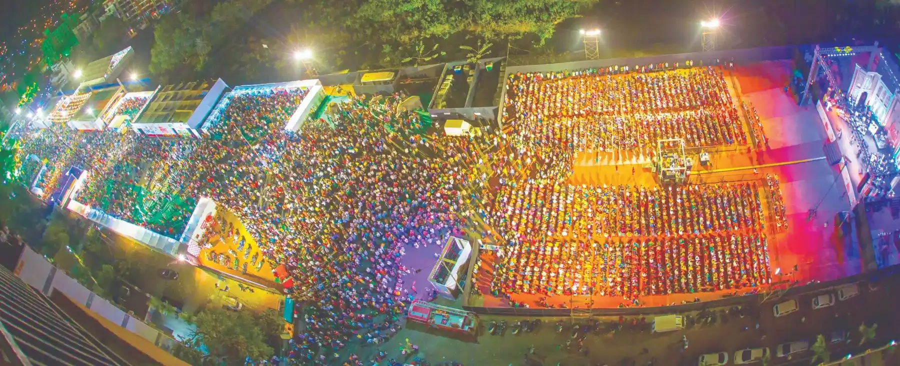 A panoramic aerial view of an enormous festival crowd