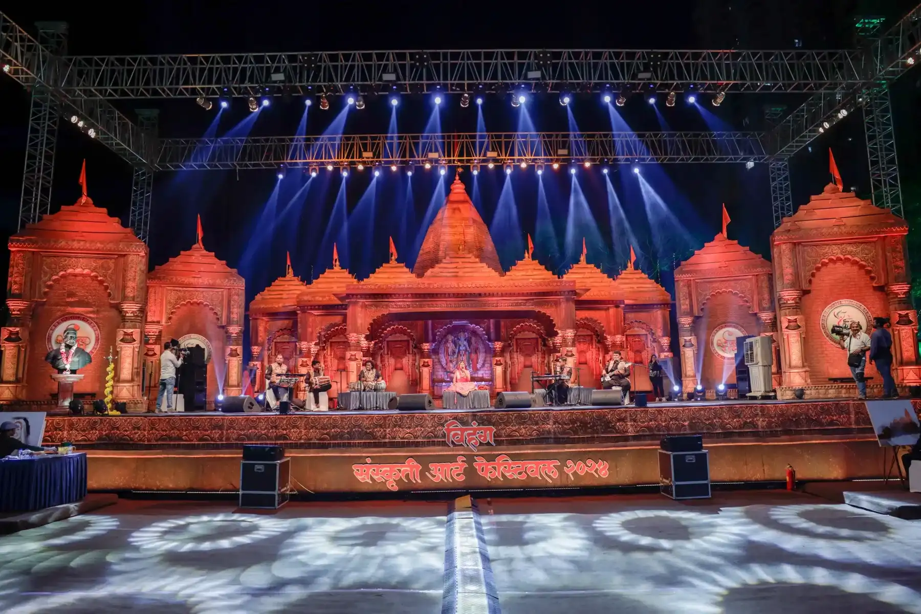 An ornate festival main stage lit for a live cultural performance
