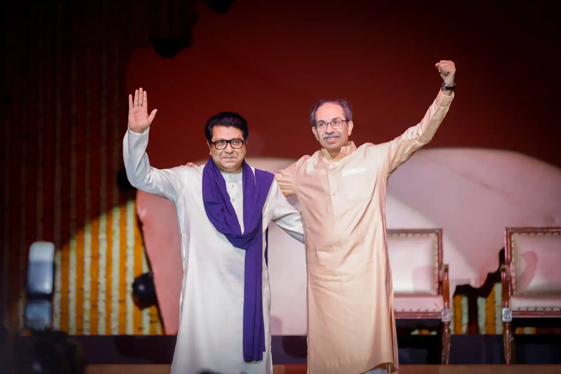 Public figures greeting the crowd from a political event stage