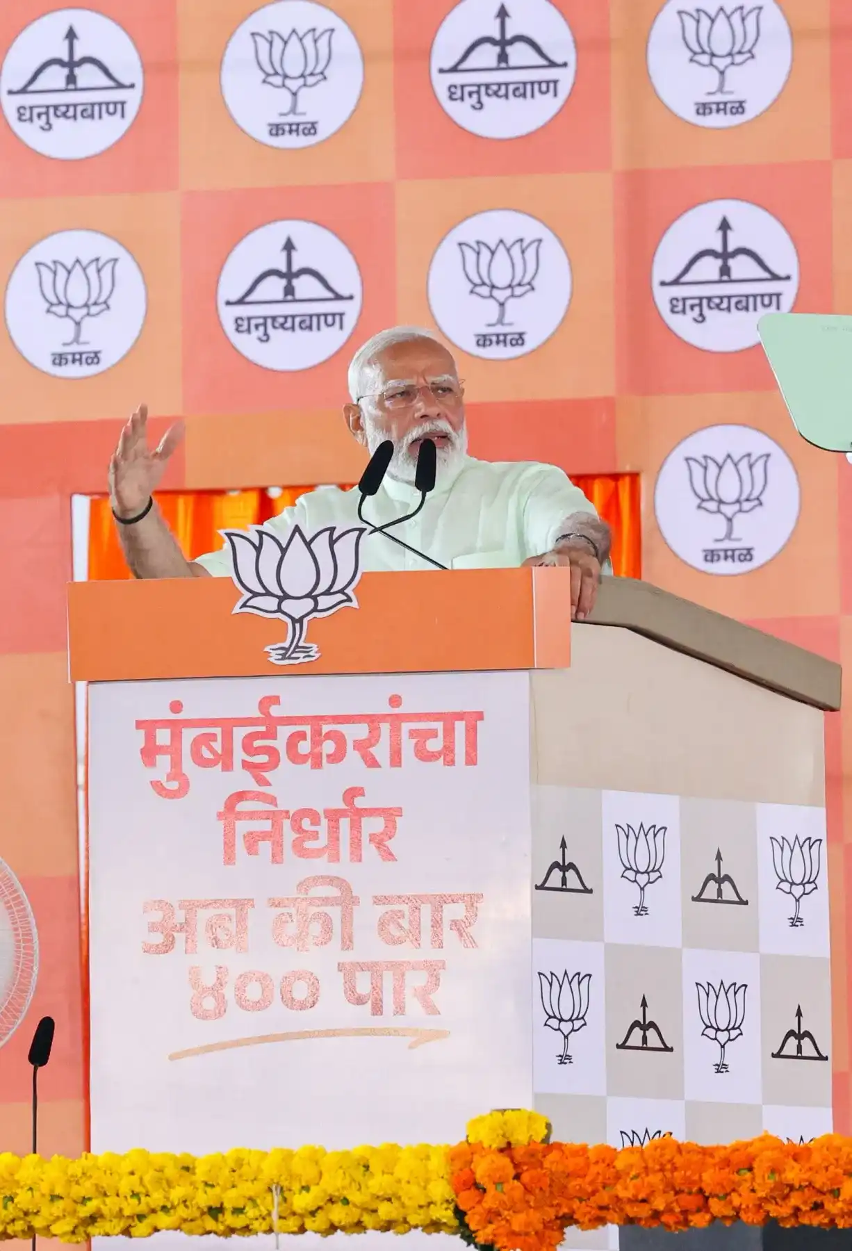 A speaker addressing a political gathering from a branded podium
