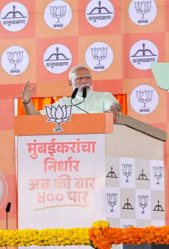 A speaker addressing a political gathering from a branded podium