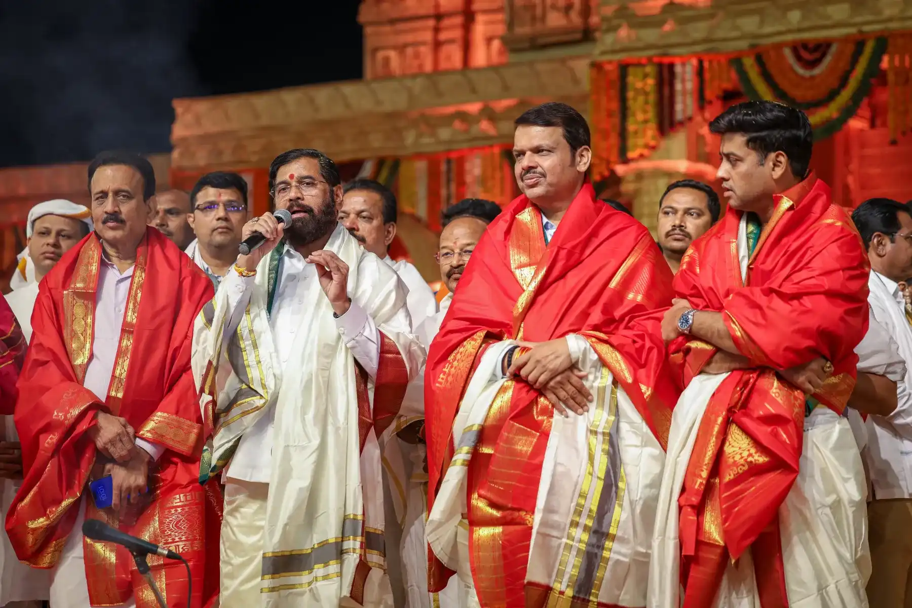 Public figures on a political event stage produced by Light and Shade