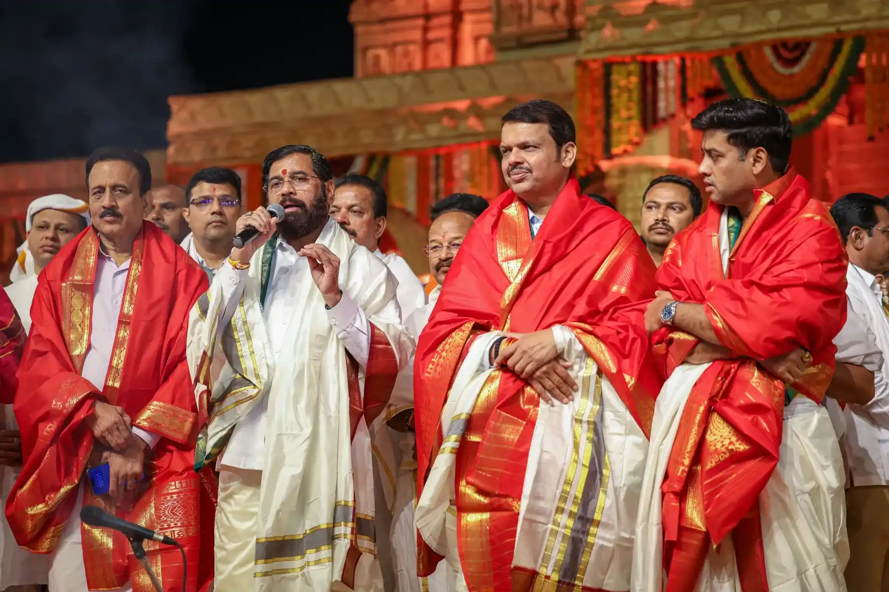 Public figures on a political event stage produced by Light and Shade