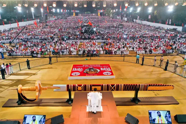 Aerial view of a night political rally with a custom fabricated sword stage and a vast crowd