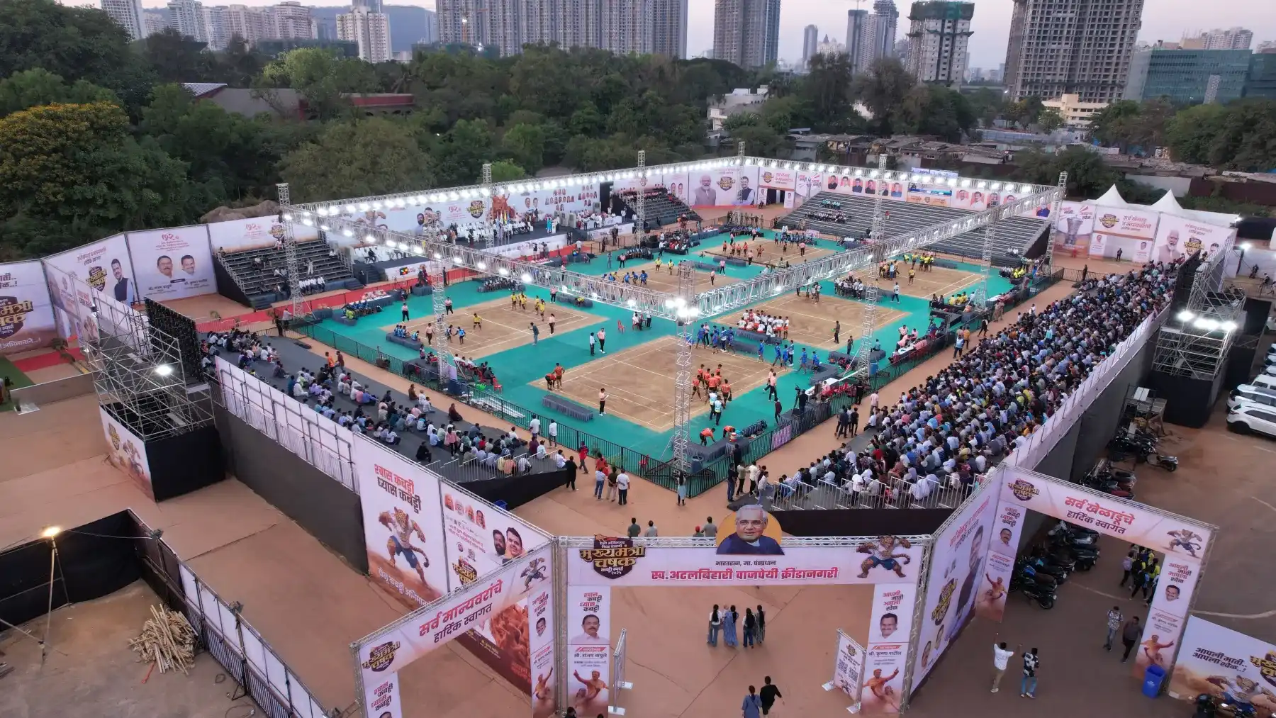 Aerial view of a sports tournament ground with courts and packed seating galleries