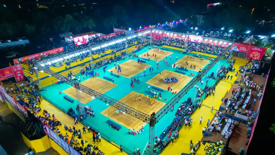 Floodlit kabaddi courts seen from above, with a packed crowd